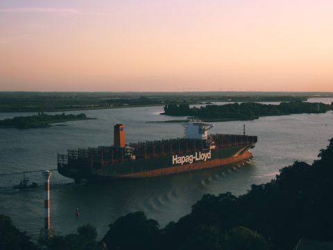 black and orange cargo ship sailing